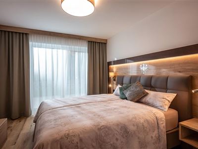 Söll_APARTdeluxe_Gartensuite_Schlafzimmer_WilderKa
