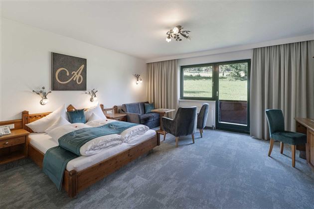 Una habitación cómoda con una gran cama doble y una hermosa vista al exterior. La decoración es moderna y acogedora.